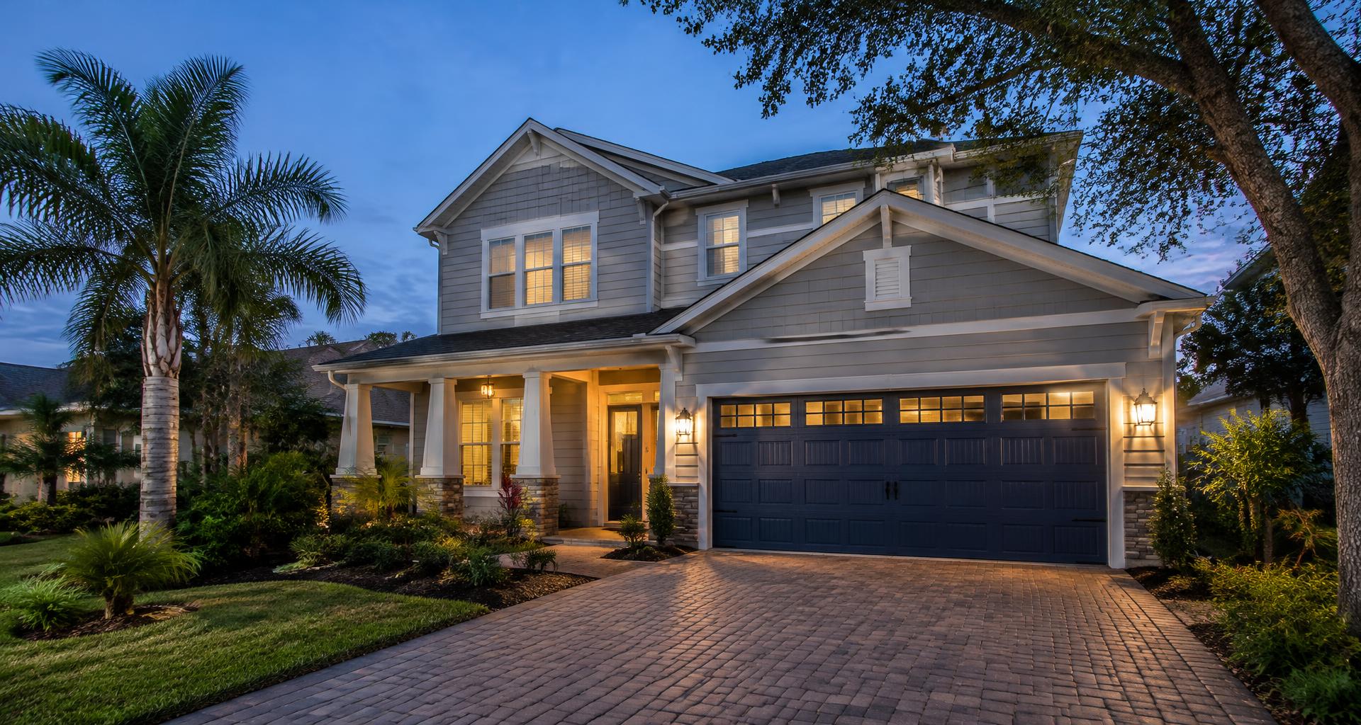 Florida home with a new navy garage door at dusk