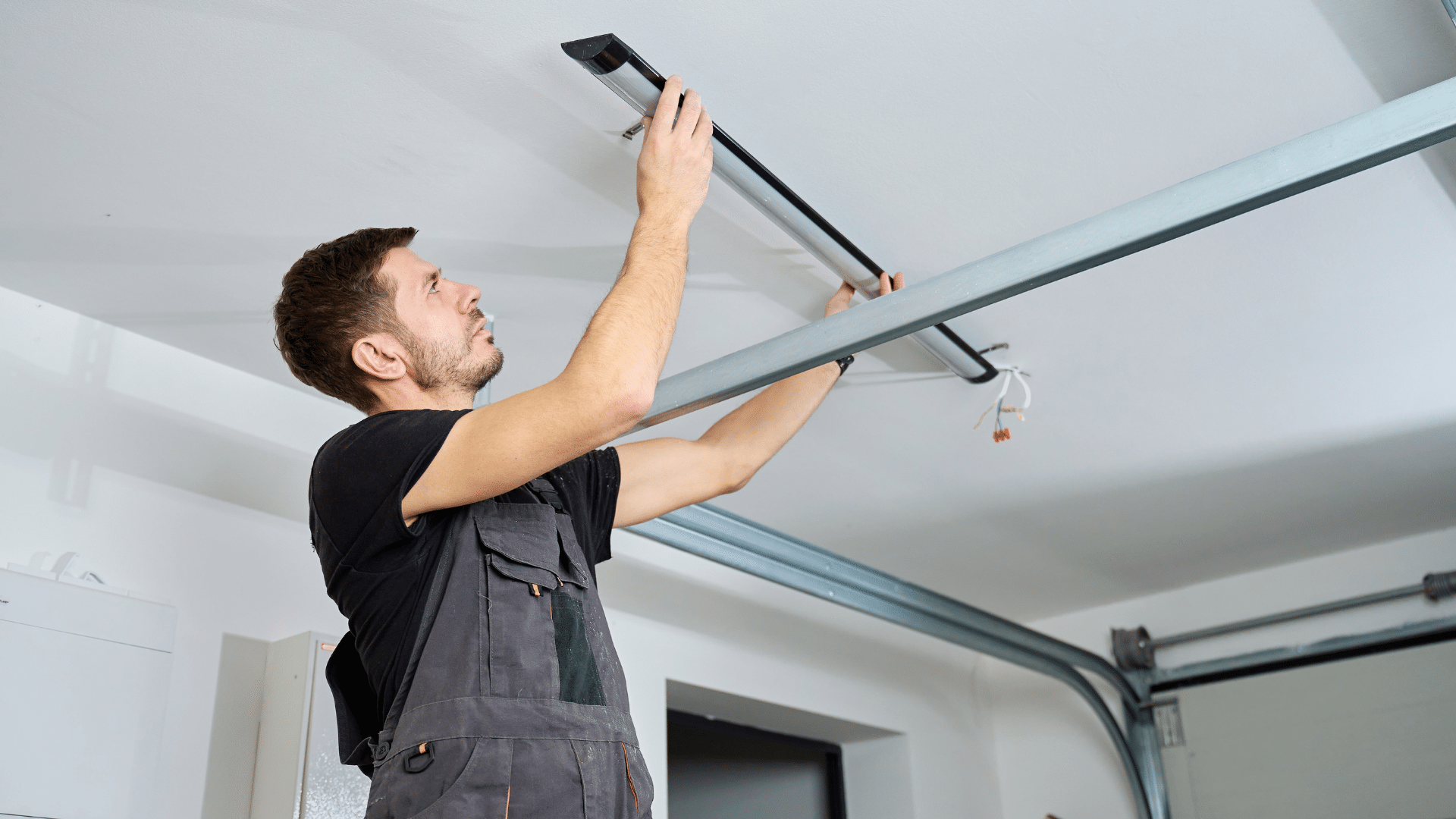 Technician inspecting the horizontal track after a garage door came off track